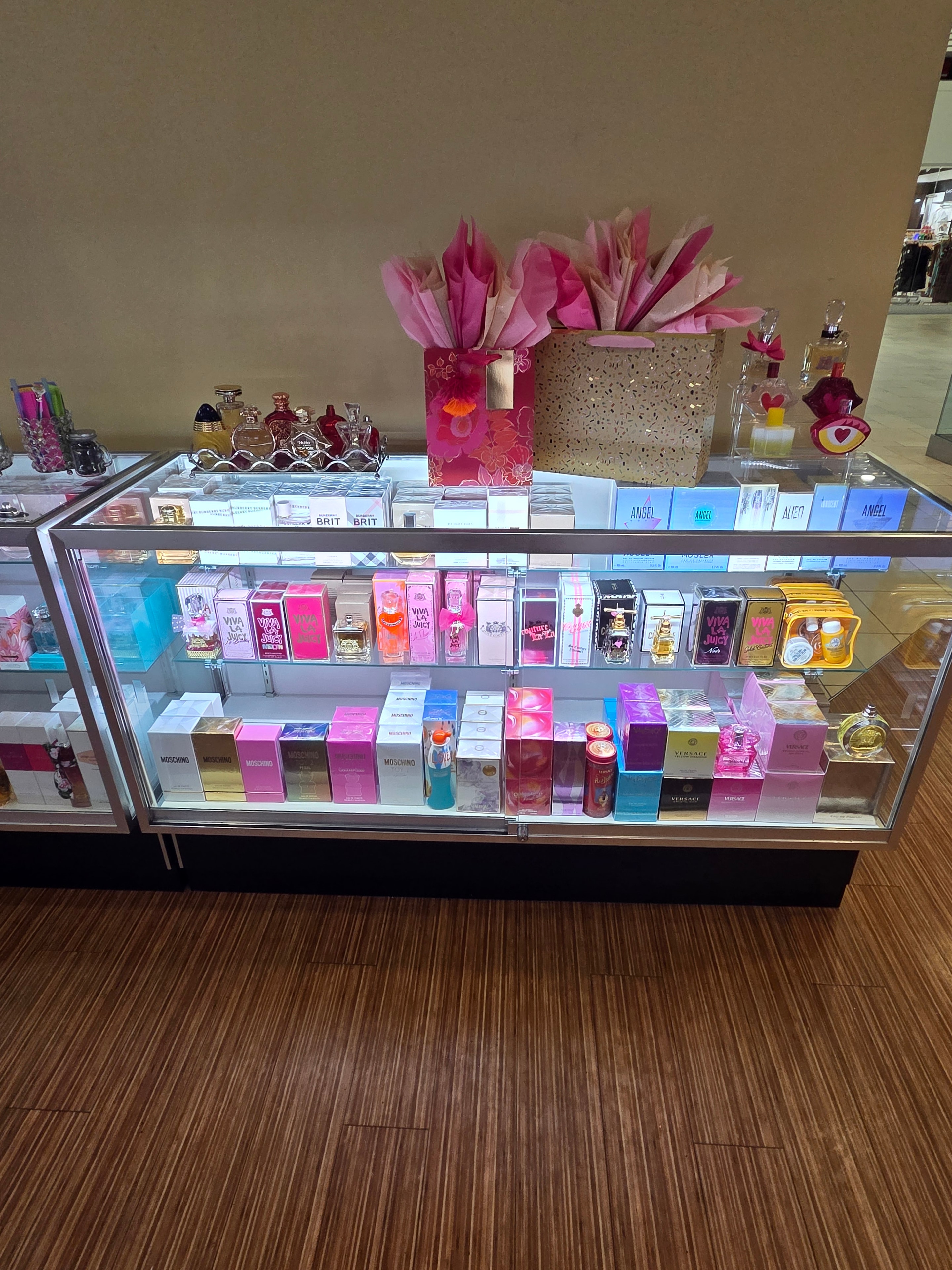 Colorful display case with pink and vibrant feminine fragrances