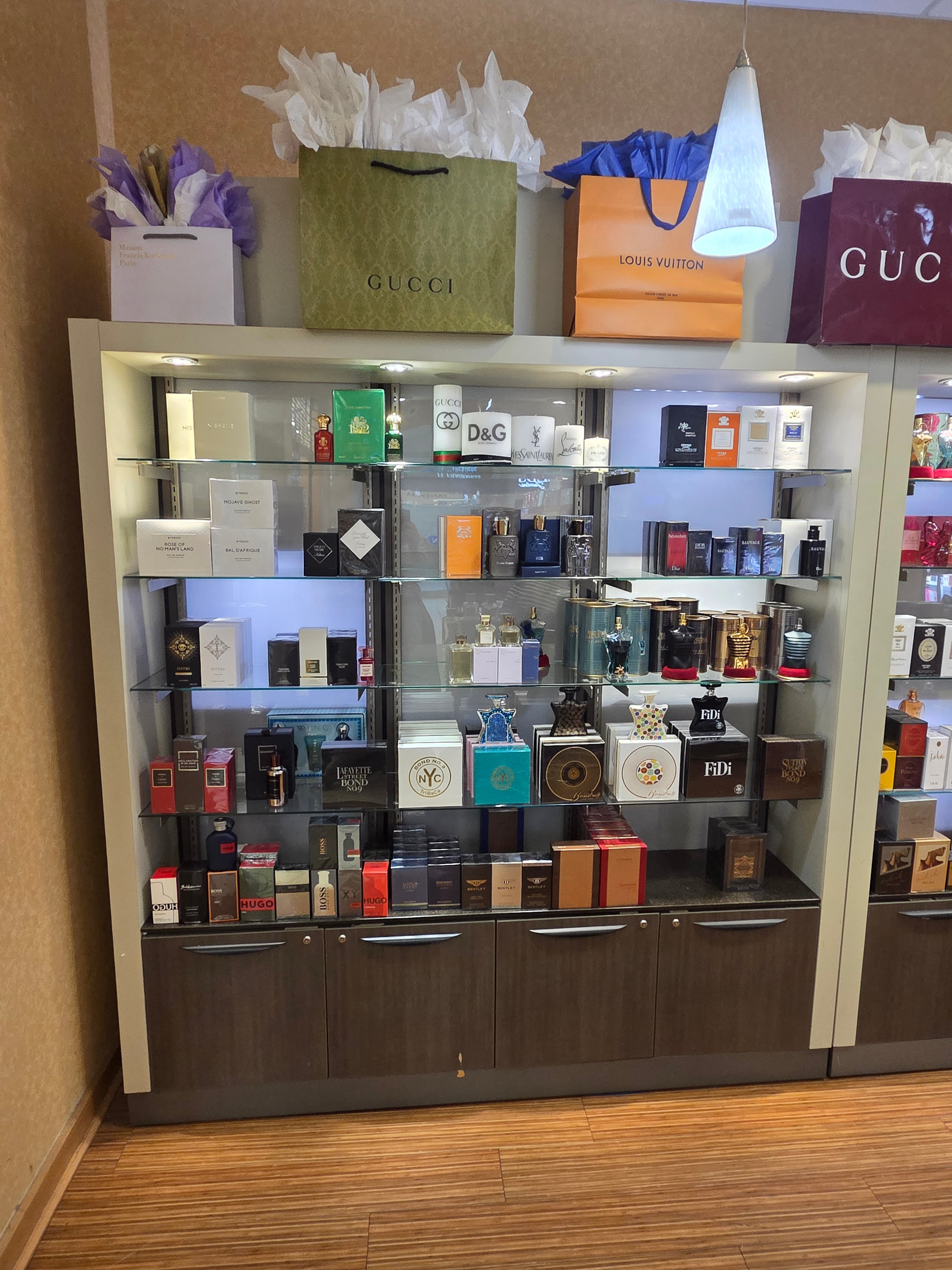 Display case with masculine fragrance brands and luxury packaging
