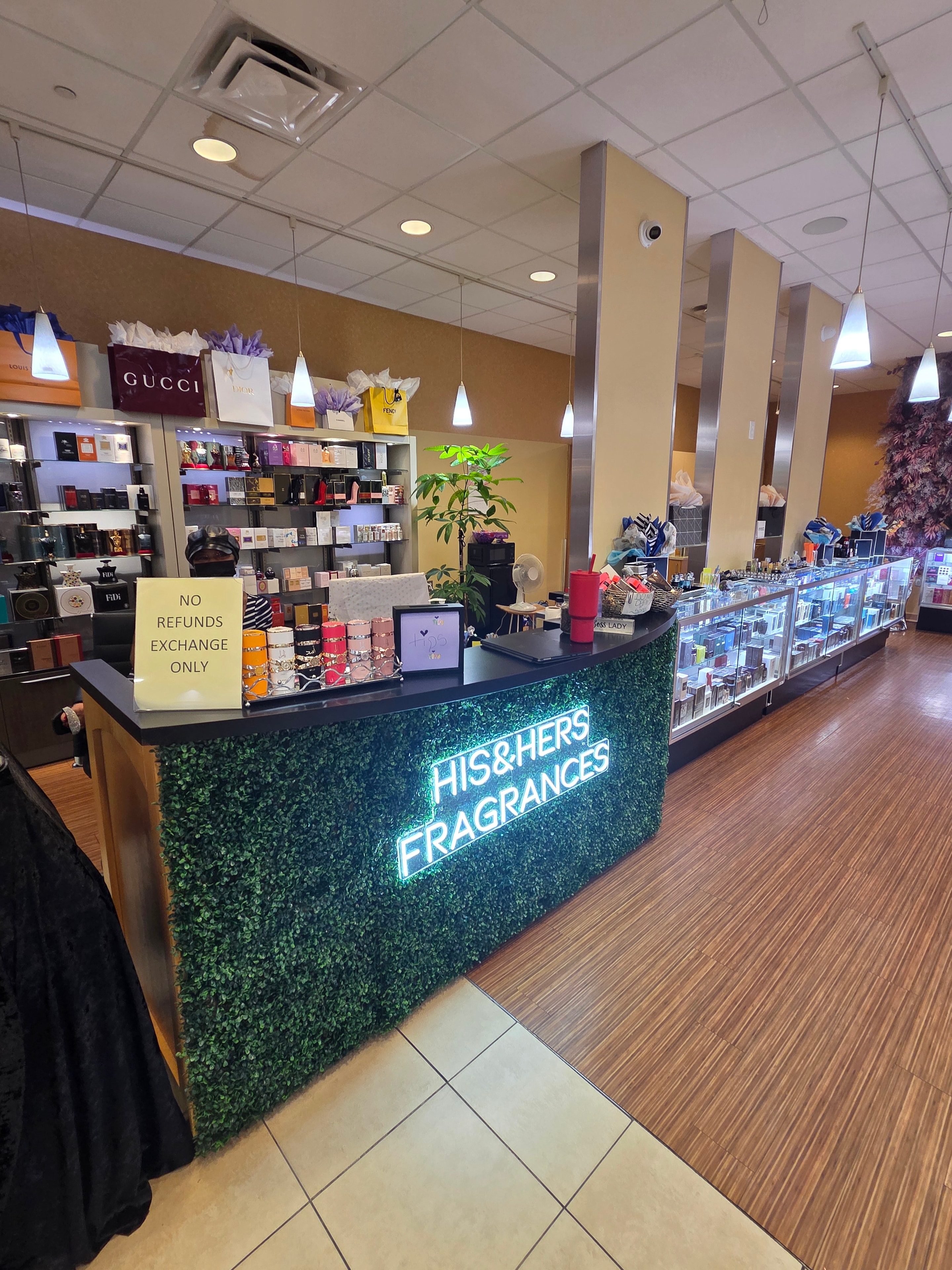 His and Hers Fragrances neon sign and store interior
