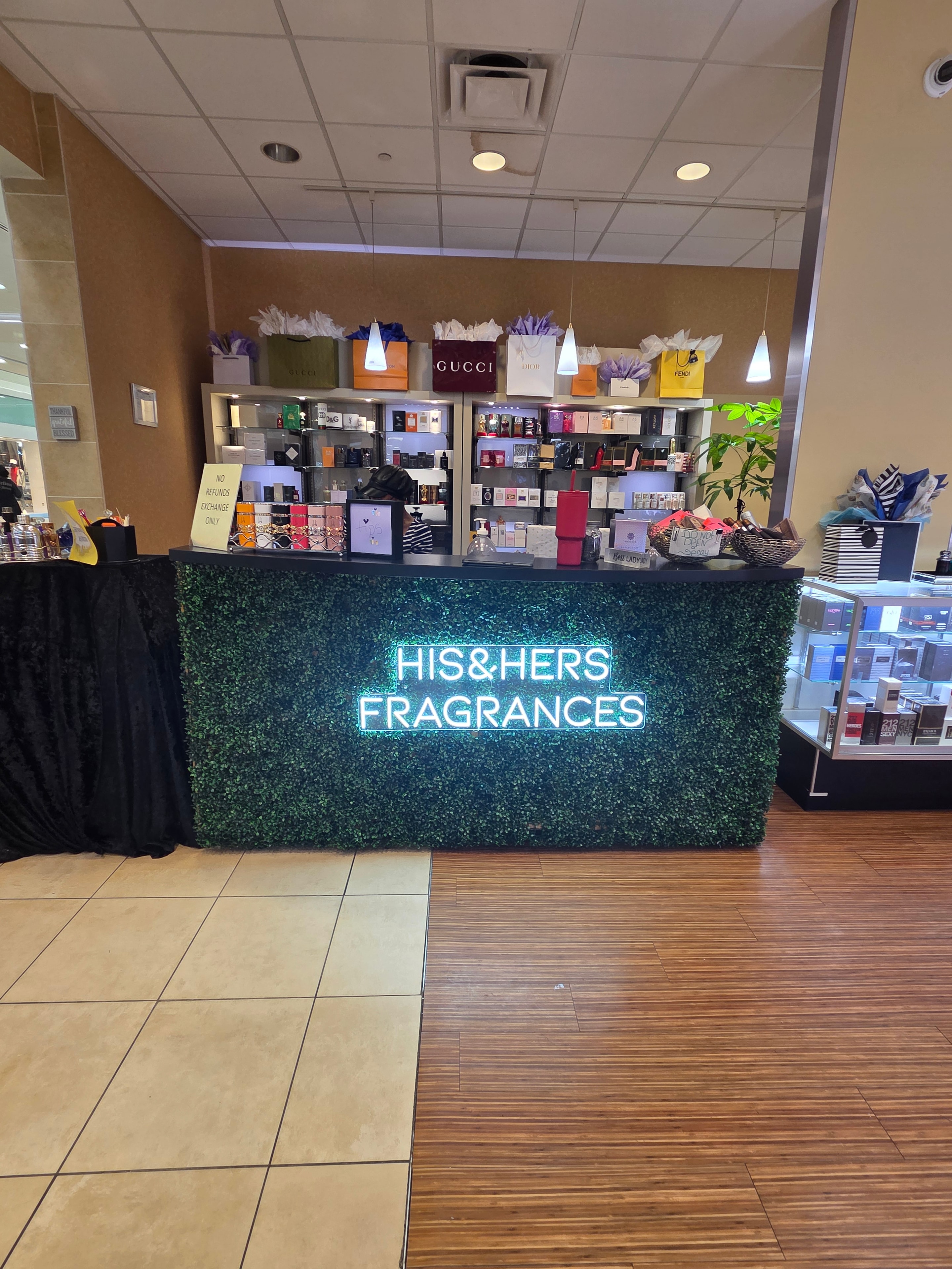 His and Hers Fragrances store — neon sign and fragrance displays